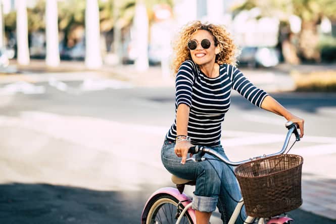 happy woman riding bike