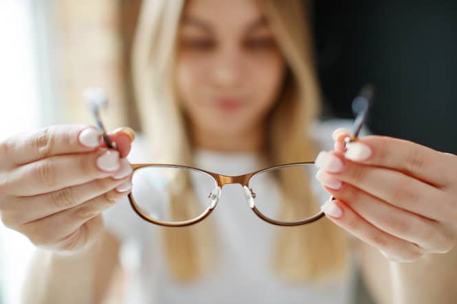 woman getting rid of glasses