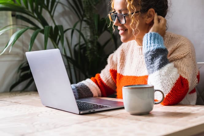 woman wearing glasses researching on laptop woman wearing glasses researching on laptop